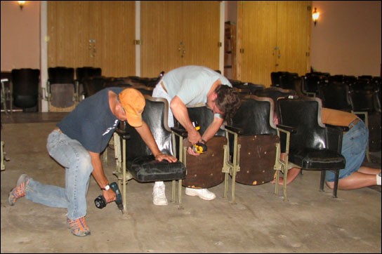 Mike Willis, Mike Schmieder, and Dick Davies (partially hidden) remove old auditorium seating � 2011 Kurt Schlicher